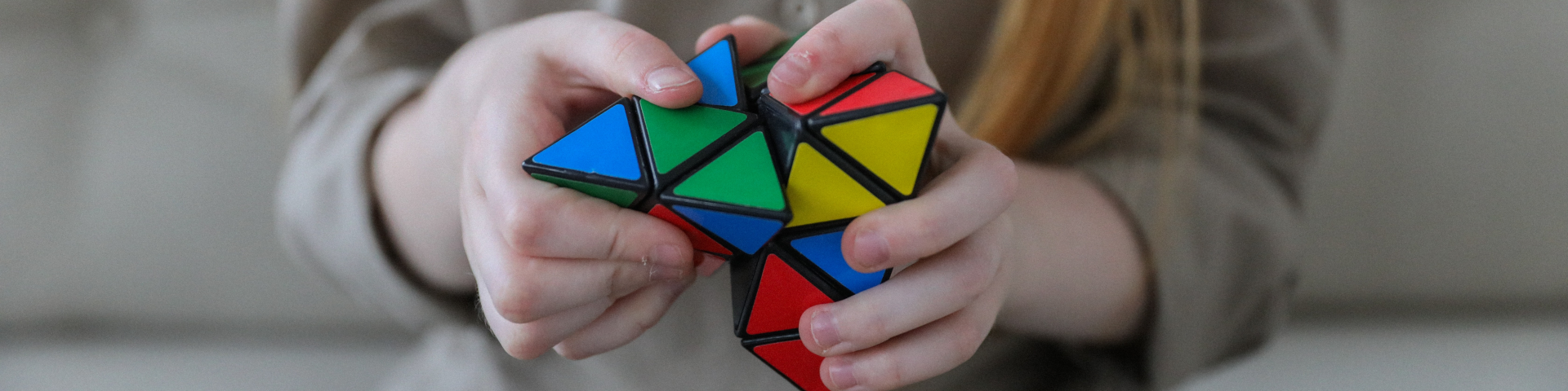 person playing with triangular Rubik's Cube